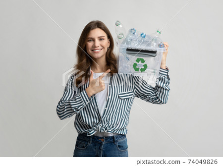 Cheerful Eco Volunteer Woman Pointing At Container With Plastic Waste For Recycling 74049826