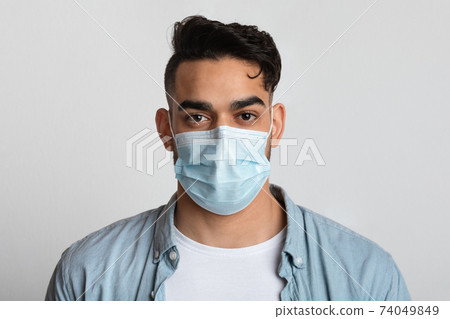 Closeup Portrait Of Young Arab Man In Protective Medical Mask On Face Closeup Portrait Of Young Arab Man In Protective Medical Mask On Face 74049849