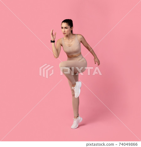 Young Lady Running And Exercising Isolated On Pink Background Young Lady Running And Exercising Isolated On Pink Background 74049866