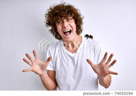 young caucasian man in a white T-shirt with spider on a white background young caucasian man in a white T-shirt with spider on a white background 74050294