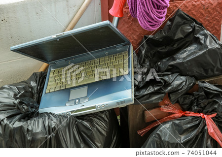Old computer notebook put into Dustbin Old computer notebook put into Dustbin 74051044