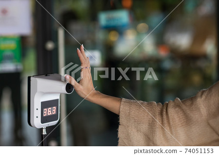 Automatic measuring temperature woman at hospital .Covid-19 test temperature for human. 74051153