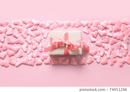 Empty blank for Valentine card with gift and pink romantic hearts on pink. Greeting card with copy space. 74051286