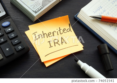 Inherited IRA memo on the color paper and calculator. 74051541