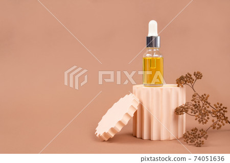 Mockup image of dropper bottle with modern organic cosmetics - polyglutamic or hyaluronic acid, serum, moisturizer, facial anti-aging oil. Trendy neutral biege still life composition, selective focus Mockup image of dropper bottle with modern organic cosmetics - polyglutamic or hyaluronic acid, serum, moisturizer, facial anti-aging oil. Trendy neutral biege still life composition, selective focus 74051636