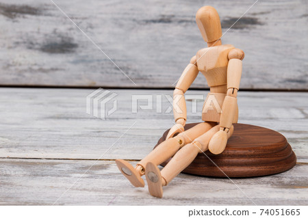 Sitting mannequin on wood. 74051665