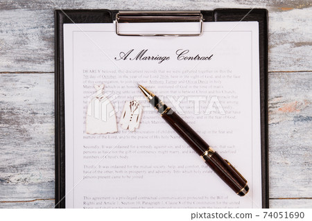 Marriage contract and pen top view. 74051690