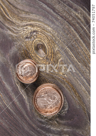 Two stacks of coins on wood. Two stacks of coins on wood. 74051797