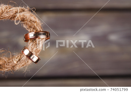 Wedding rings on the thread close-up. Wedding rings on the thread close-up. 74051799