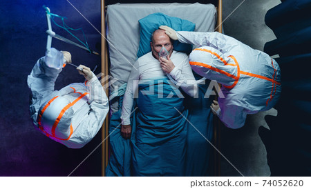 Top view of doctors and covid-19 patient with oxygen mask in bed in hospital, coronavirus concept. 74052620