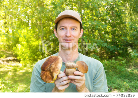 Man with mushrooms in hands Man with mushrooms in hands 74052859