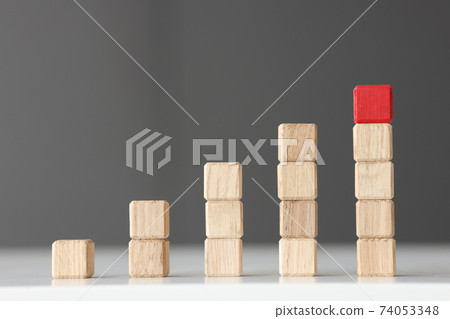 Wooden toy blocks stacked in shape of graphic 74053348