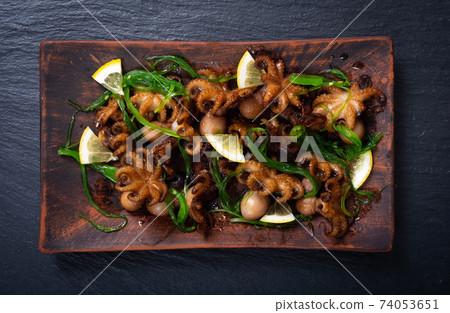 Baby octopus fried with lemon Baby octopus fried with lemon 74053651