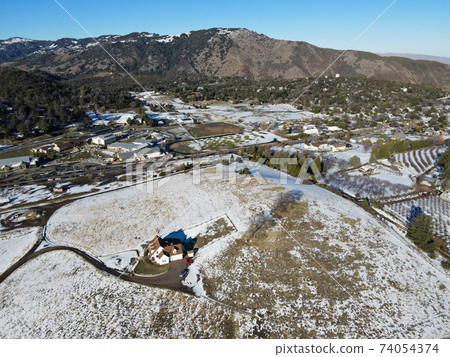 Aerial view of historic Downtown City of Julian during snow day. 74054374