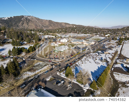 Aerial view of historic Downtown City of Julian during snow day. 74054382