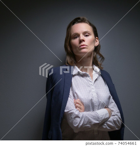 a woman in a suit looks at the camera and says no. body language a woman in a suit looks at the camera and says no. body language 74054661