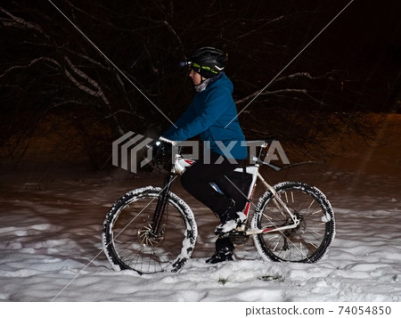 Mountain bike rider boy in winter. Young man riding fat tyre bicycle in winter Mountain bike rider boy in winter. Young man riding fat tyre bicycle in winter 74054850