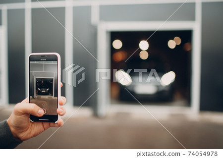 USA - New York, March 19, 2019: The new modern Mercedes Benz AMG GLE 63 S 4MATIC in dealership salon with mobile phone iPhone in hand 74054978