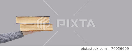 stack of old books in the palm of an invisible person stack of old books in the palm of an invisible person 74056609