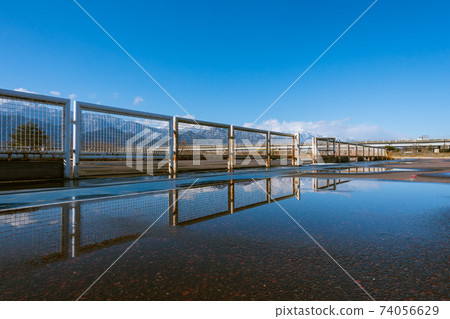 Puddle and fence Puddle and fence 74056629