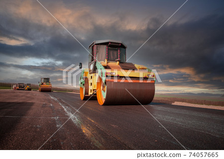 Large view on the road rollers working on the new road construction site 74057665