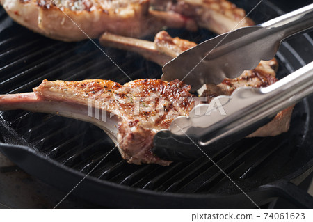 Bake lamb chops in a grill pan 74061623