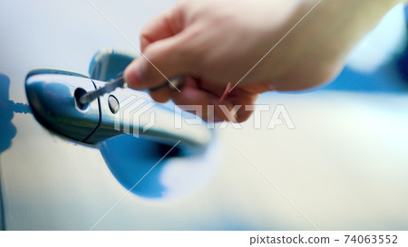 Male hand unlocking a car door 74063552