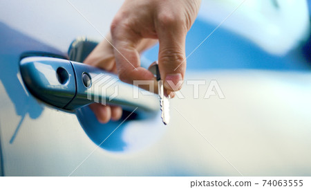 Male hand unlocking a car door 74063555