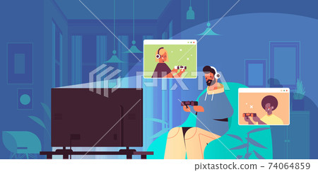 man playing video games on tv with mix race friends in web browser windows during virtual conference man playing video games on tv with mix race friends in web browser windows during virtual conference 74064859