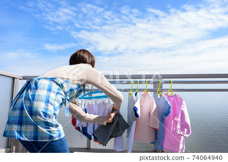 Housewife drying laundry Housewife drying laundry 74064940
