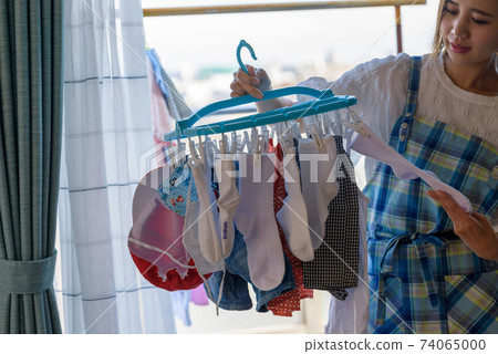 Housewife taking in the laundry 74065000
