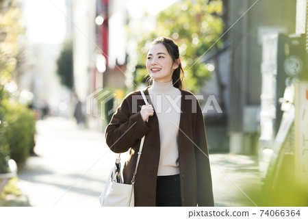 A young lady walking in the city A young lady walking in the city 74066364
