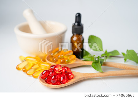 Alternative medicine herbal organic capsule with vitamin E omega 3 fish oil, mineral, drug with herbs leaf natural supplements for healthy good life. Alternative medicine herbal organic capsule with vitamin E omega 3 fish oil, mineral, drug with herbs leaf natural supplements for healthy good life. 74066665