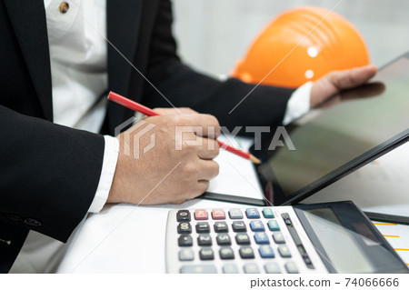 Asian accountant working and analyzing financial reports project accounting with chart graph and calculator in modern office,finance and business concept. Asian accountant working and analyzing financial reports project accounting with chart graph and calculator in modern office,finance and business concept. 74066666