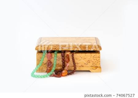 Jasper, agate and nephritis beads in wooden jewelry box isolated on white background Jasper, agate and nephritis beads in wooden jewelry box isolated on white background 74067527