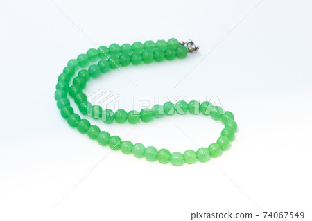 Green nephritis beads isolated on white background Green nephritis beads isolated on white background 74067549