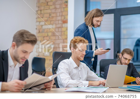 Group of men concentratedly busy in office 74068755