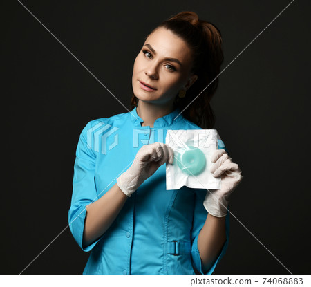 Young woman doctor nurse in blue uniform and 74068883
