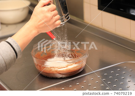 Preparing chocolate cake for grandson's birthday 74070219