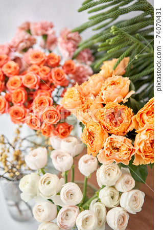 Set of white, green and orange flowers for Interior decorations. The work of the florist at a flower shop. Fresh cut flower. Set of white, green and orange flowers for Interior decorations. The work of the florist at a flower shop. Fresh cut flower. 74070431