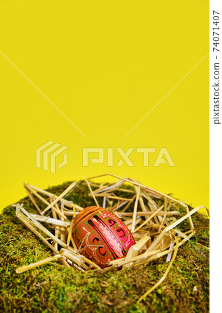 easter basket with easter eggs on Yellow background 74071407