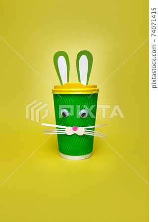 cardboard cup of coffee, with ears and a rabbit face 74071415