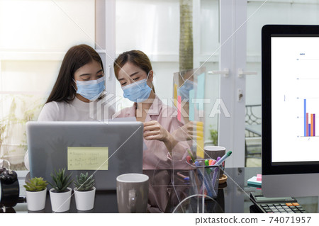 Asian Business Team Meeting Brainstorming Business start up working at Private Home Office social distancing among Coronavirus outbreak New generation business people meeting analysis work from laptop 74071957