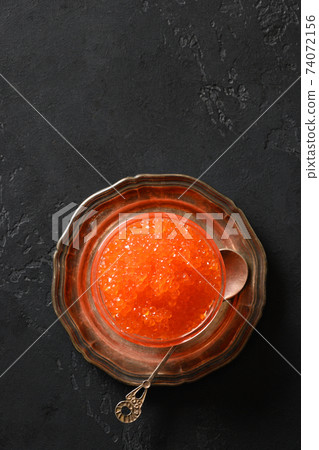 Red caviar on ice cube. Red caviar on ice cube. 74072156