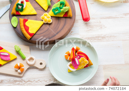 Children's hands playing with felt pizza Children's hands playing with felt pizza 74072184