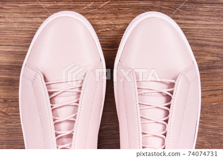 Womanly leather shoes on board. Wooden background Womanly leather shoes on board. Wooden background 74074731