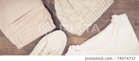 Vintage photo, Womanly clothing and accessories on board, leather shoes, pants, cap and sweater Vintage photo, Womanly clothing and accessories on board, leather shoes, pants, cap and sweater 74074732