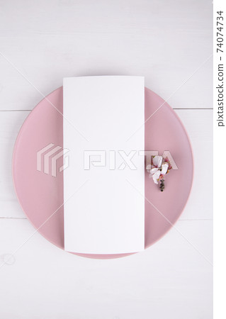 Menu card mockup with blooming almond branch on a pink plate Menu card mockup with blooming almond branch on a pink plate 74074734