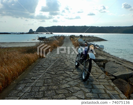 With a motorcycle at Kinan Tamanoura Beach ... 74075136