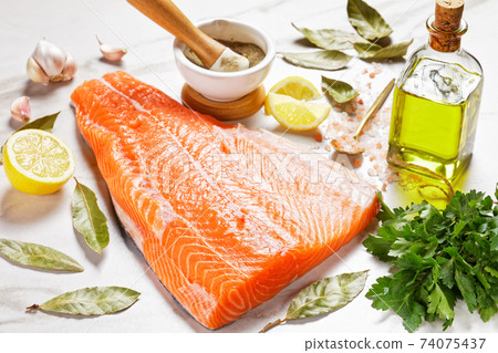 raw salmon fillet on a marble table 74075437